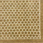 Handknotted rug sample in a small scale hex lattice in cream on an ochre field with a border at the right and bottom. 