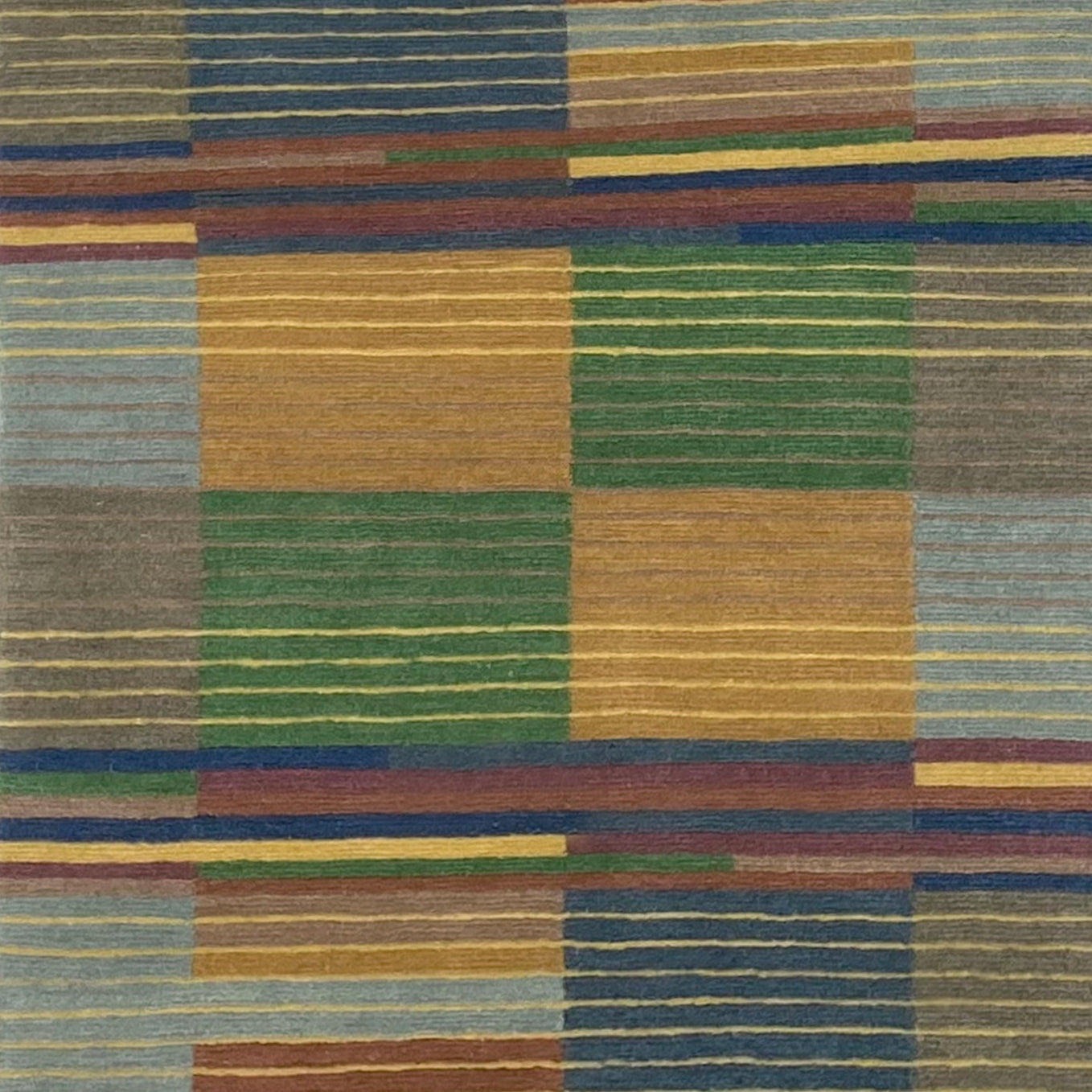 Handknotted rug sample in a complex broken stripe design in blue, green, yellow, grey and tan. 