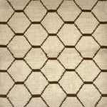 Handknotted Moroccan style rug with a brown lattice on a cream field.