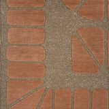 Handknotted carpet in a raised geometric design in peach on a taupe field.
