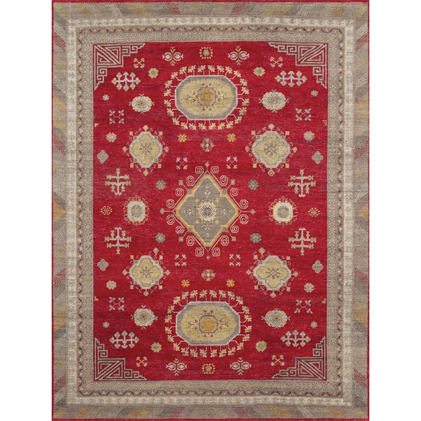 Decorative red rug with geometric patterns on a plain background