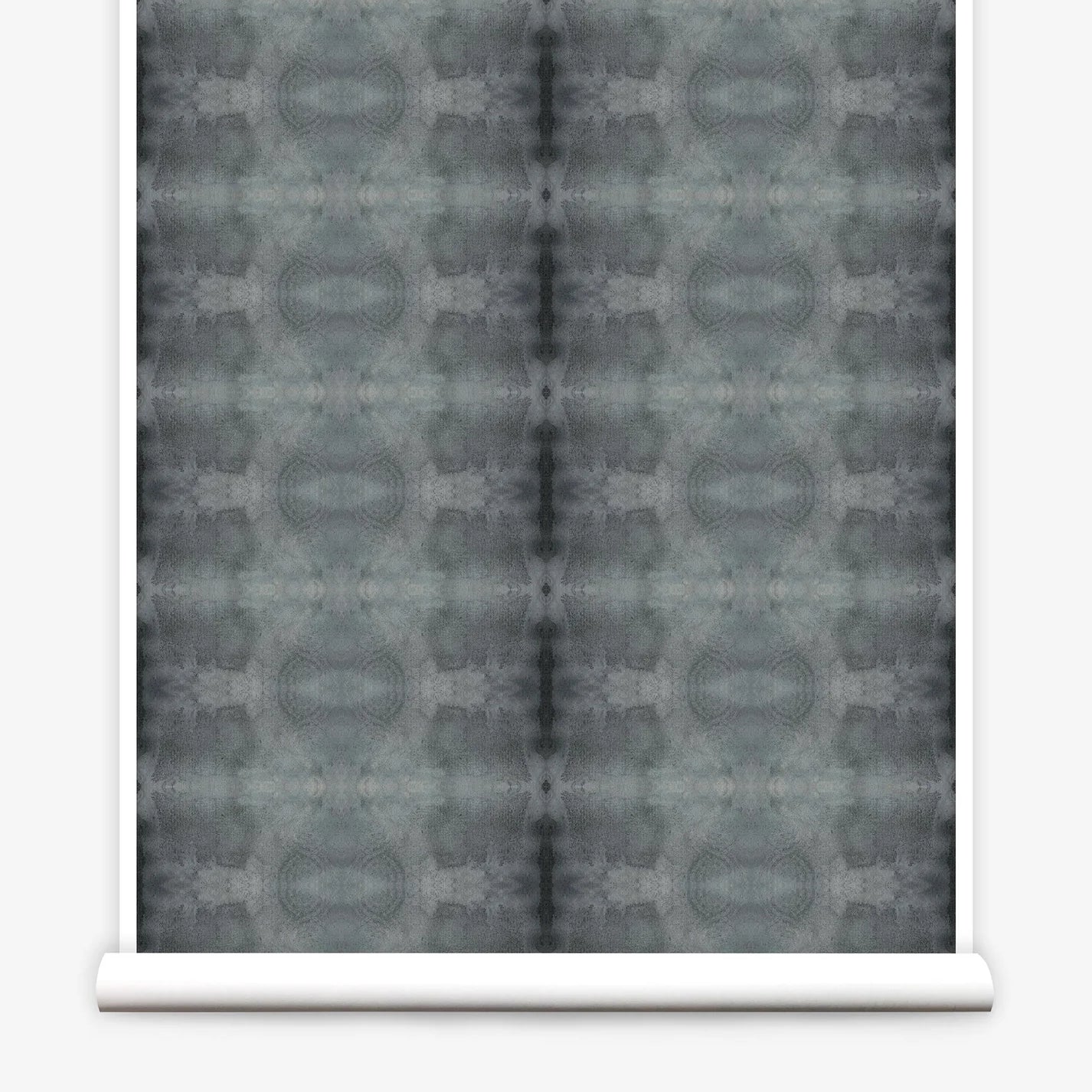 Partially unrolled wallpaper yardage in a repeating ink blot print in shades of gray.