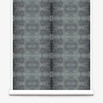 Partially unrolled wallpaper yardage in a repeating ink blot print in shades of gray.