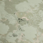 Detail of wallpaper in a dense photorealistic floral print in shades of gray and pastel green.