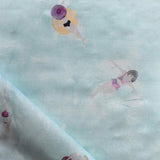 Fabric with watercolor characters swimming on a light blue background