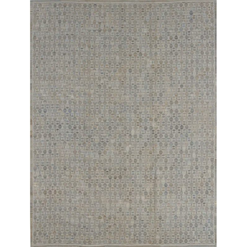 Patterned rug with geometric design in  cool grey on a plain background