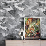 Framed artwork on a wooden surface with a watercolor gray wallpaper in the background