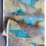 Wallpaper in a watercolor design in brown and teal gently draped on itself. 