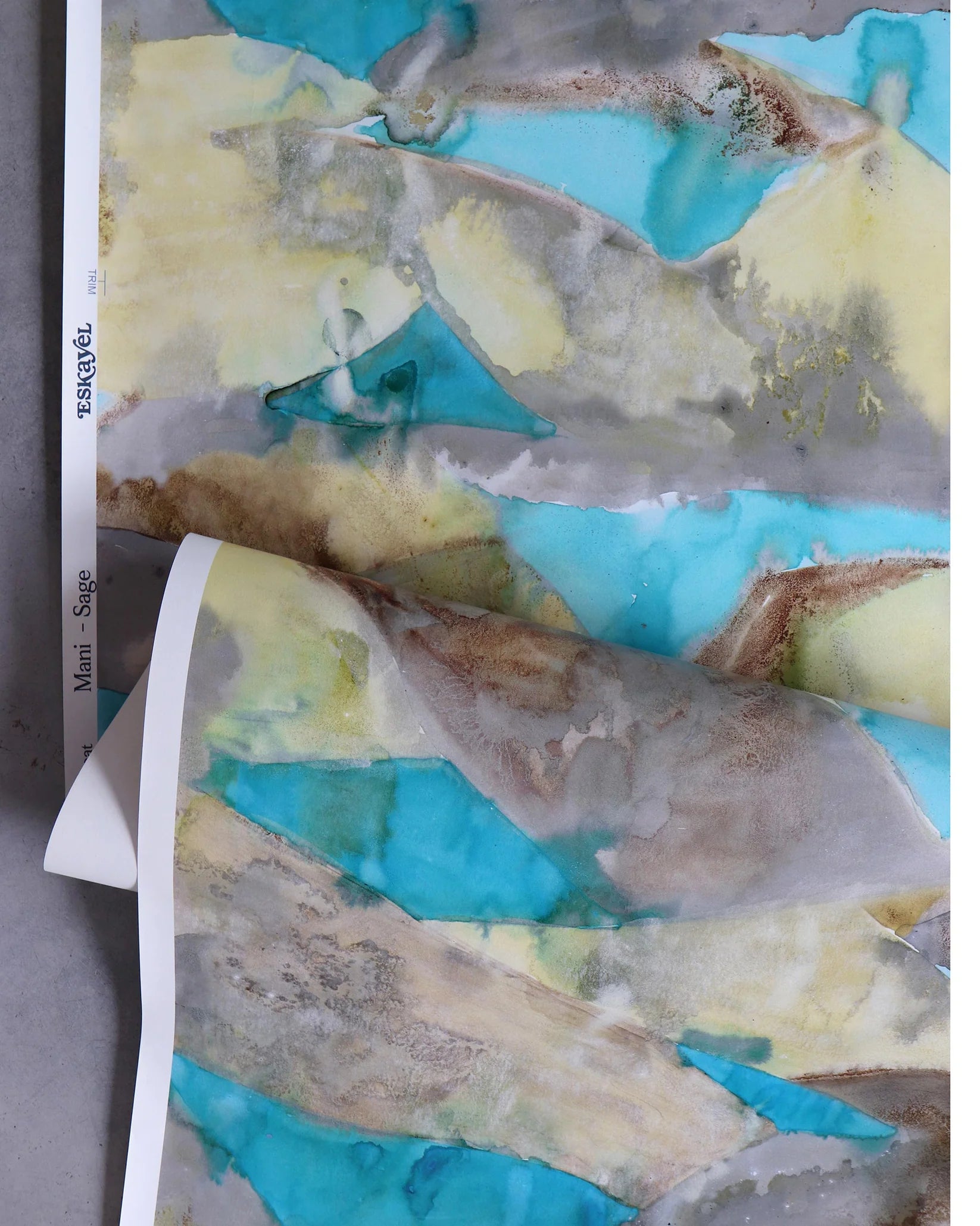 Wallpaper in a watercolor design in brown and teal gently draped on itself. 