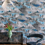 Room interior with abstract patterned wallpaper, table, and chairs.