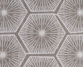 Fabric in a geometric lattice print in white on a light brown field.