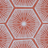 Fabric in a geometric lattice print in white on a red field.