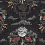 Detail of fabric in a playful snake, plant and moon print in shades of red, brown and gray with rhinestone accents.