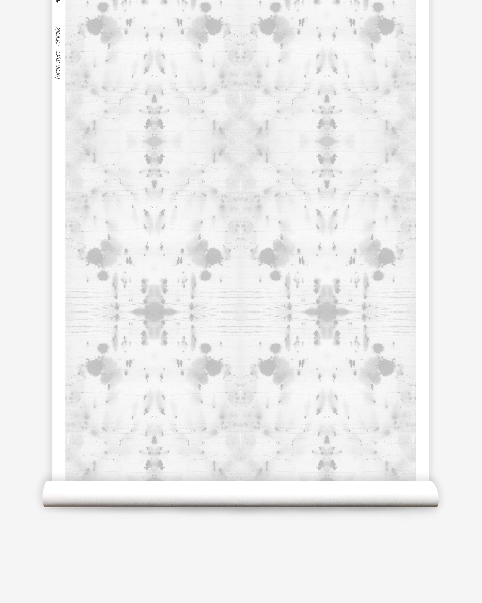 Partially unrolled wallpaper yardage in a watercolor ink blot print in gray on a white field.