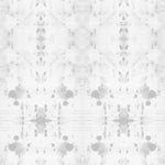 Detail of wallpaper in a watercolor ink blot print in gray on a white field.