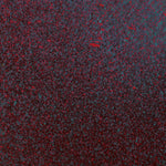 Close up of paint splatters in red, blue and black.