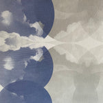 Close-up of wallpaper in a cloudy ink blot print in shades of blue and gray on a cream field.