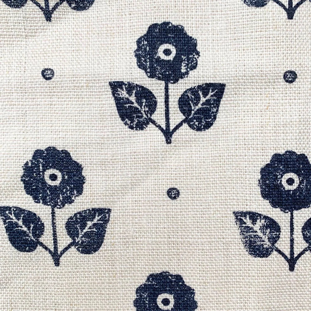 Pattern of blue flowers and leaves on a beige background