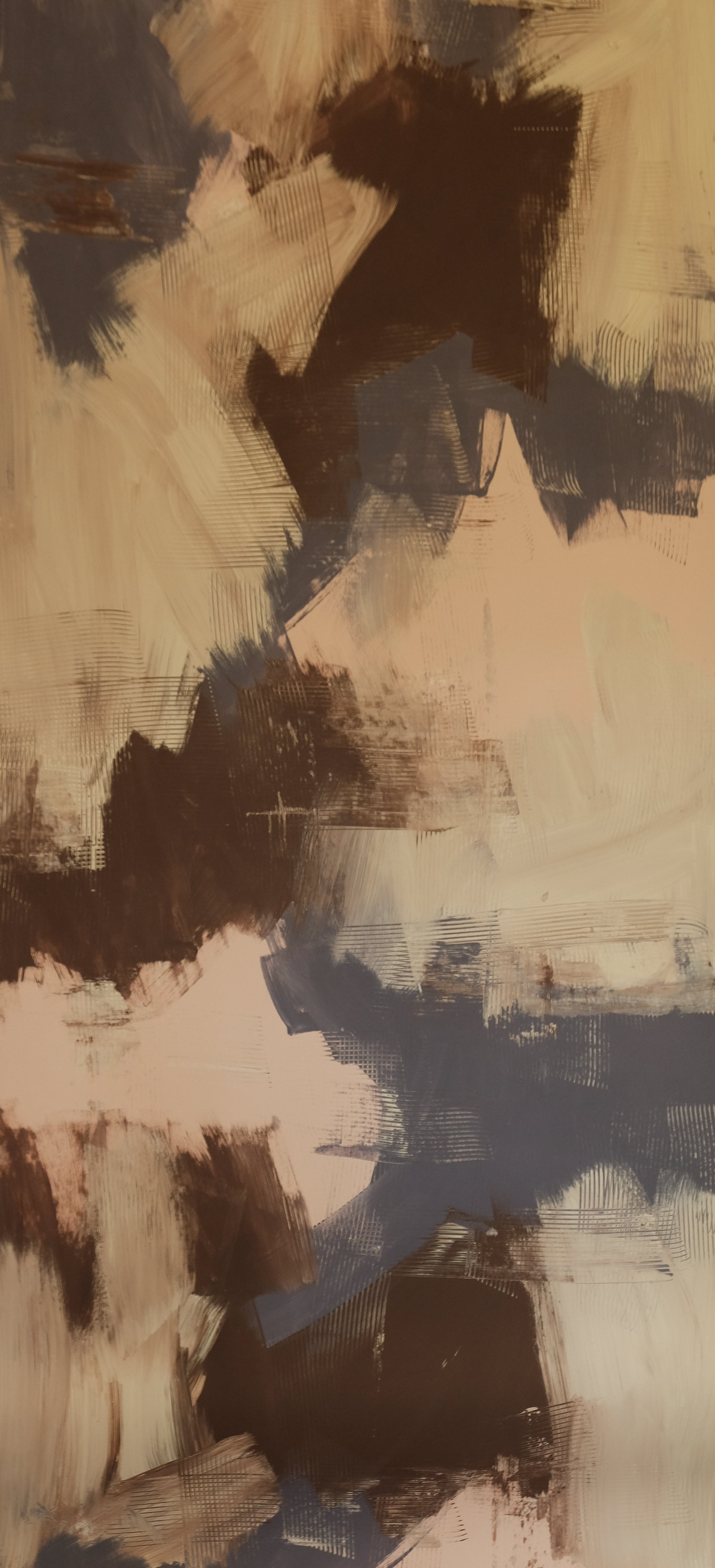 Detail of wallpaper in an abstract paint print in shades of tan, gray and brown.