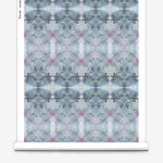 Partially unrolled wallpaper yardage in a watercolor ink blot pattern in shades of gray, blue and pink.