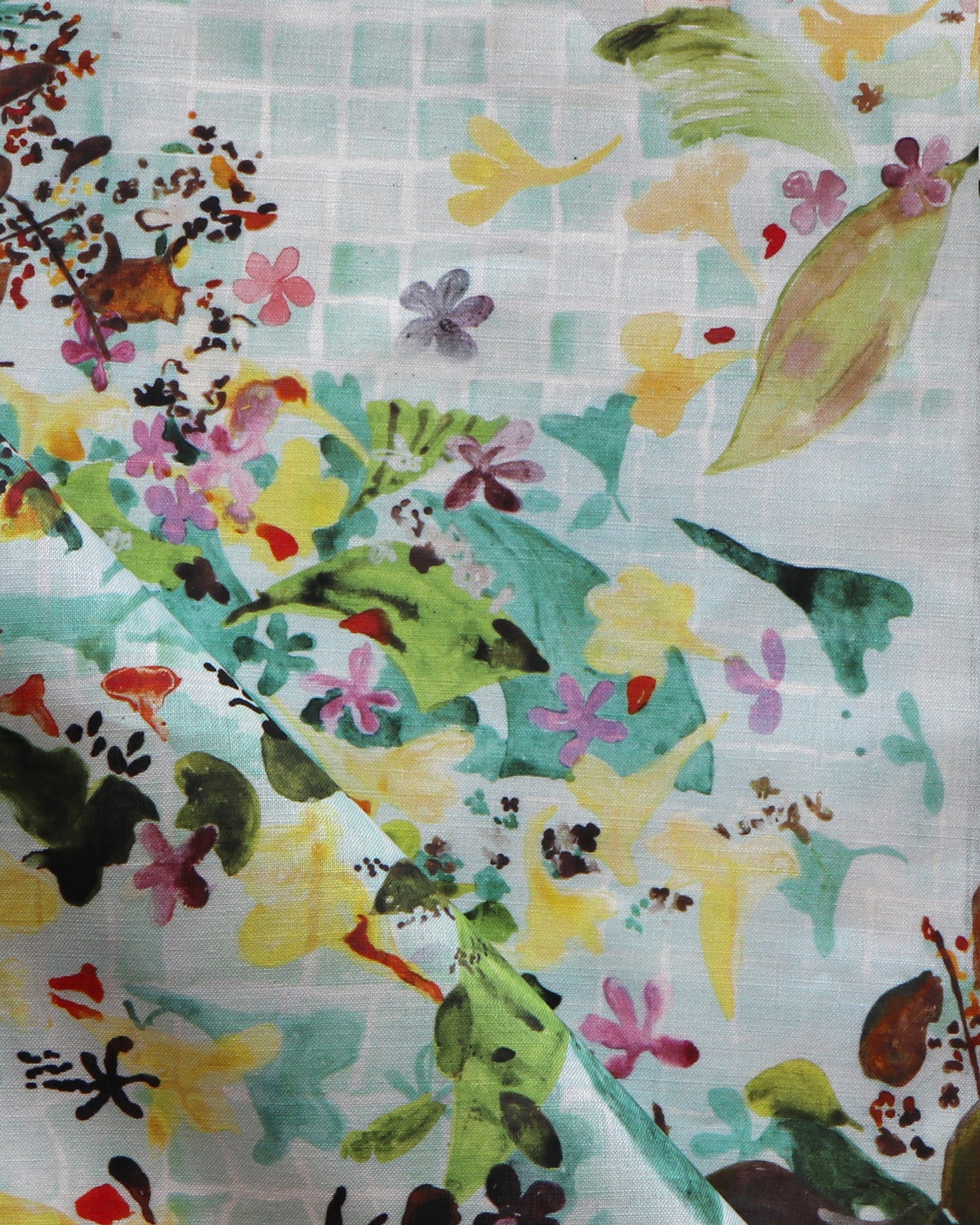 Colorful fabric with floral and leaf patterns on a blue background