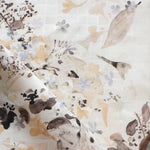 Floral patterned fabric with leaf and floral designs on a white background