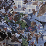 Close-up of a floral patterned fabric with blue gridded background