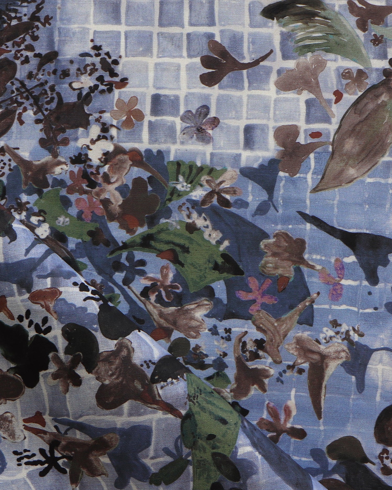 Close-up of a floral patterned fabric with blue gridded background