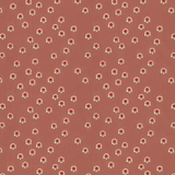 Scaled-out view of fabric in a minimal floral print in shades of pink, red and blue on a maroon field.