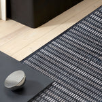 Area rug in a crisp grey and black stripe in a contemporary living setting. 