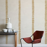 Modern red chair and table against a wall with decorative striped pattern