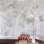 Room interior with abstract white wall design, striped stool, and floor lamp.
