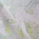 Close-up of a textured fabric with green and white patterns