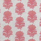 Detail of fabric in a repeating thistle print in pink and orange on a cream field.