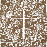 Detail of fabric in a large-scale tree and leaf print in cream on a brown field.