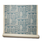 Abbot Kinney grasscloth roll: the design is geometric with triangles and squares in a teal color printed on textured grasscloth