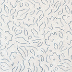 Detail of fabric in a minimalist floral print in navy on a cream field.