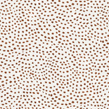 Detail of wallpaper in a scalloped dot print in rust on a cream field.