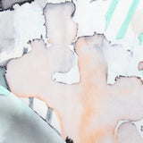 Draped fabric yardage in a watercolor watercolor print in shades of purple, orange and green on a white field.