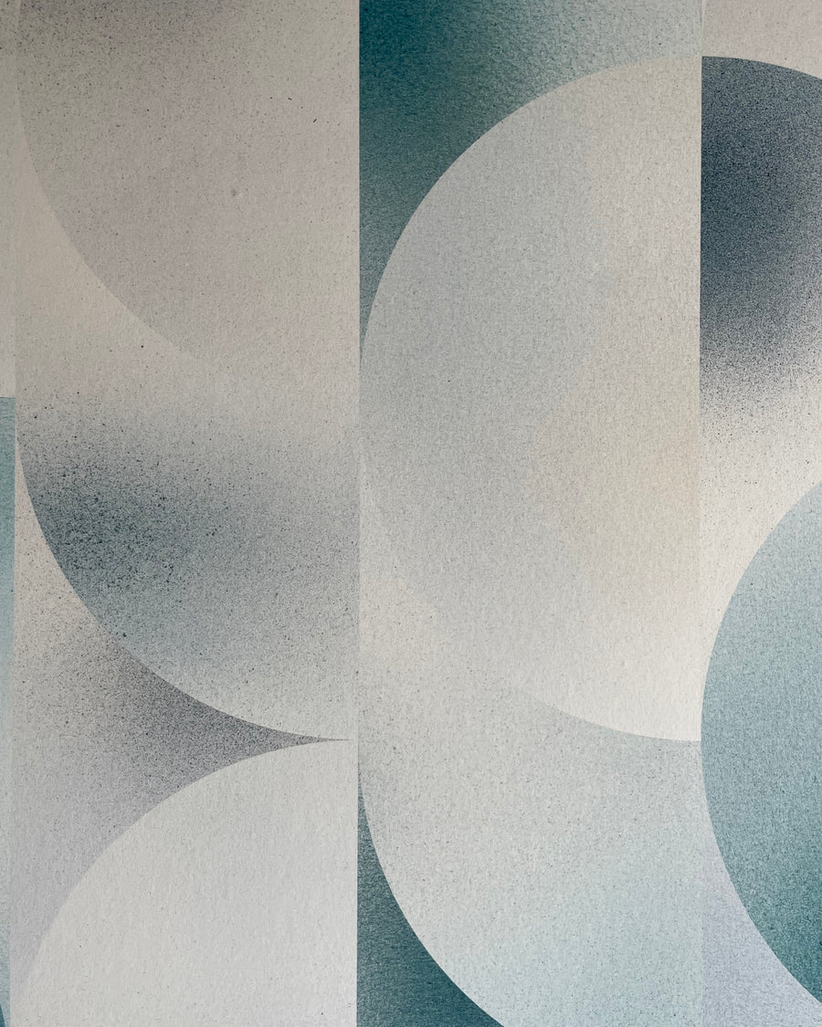 Detail of wallpaper in an abstract curvilinear print in mottled blue, gray and white.