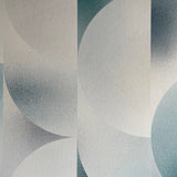 Detail of wallpaper in an abstract curvilinear print in mottled blue, gray and white.
