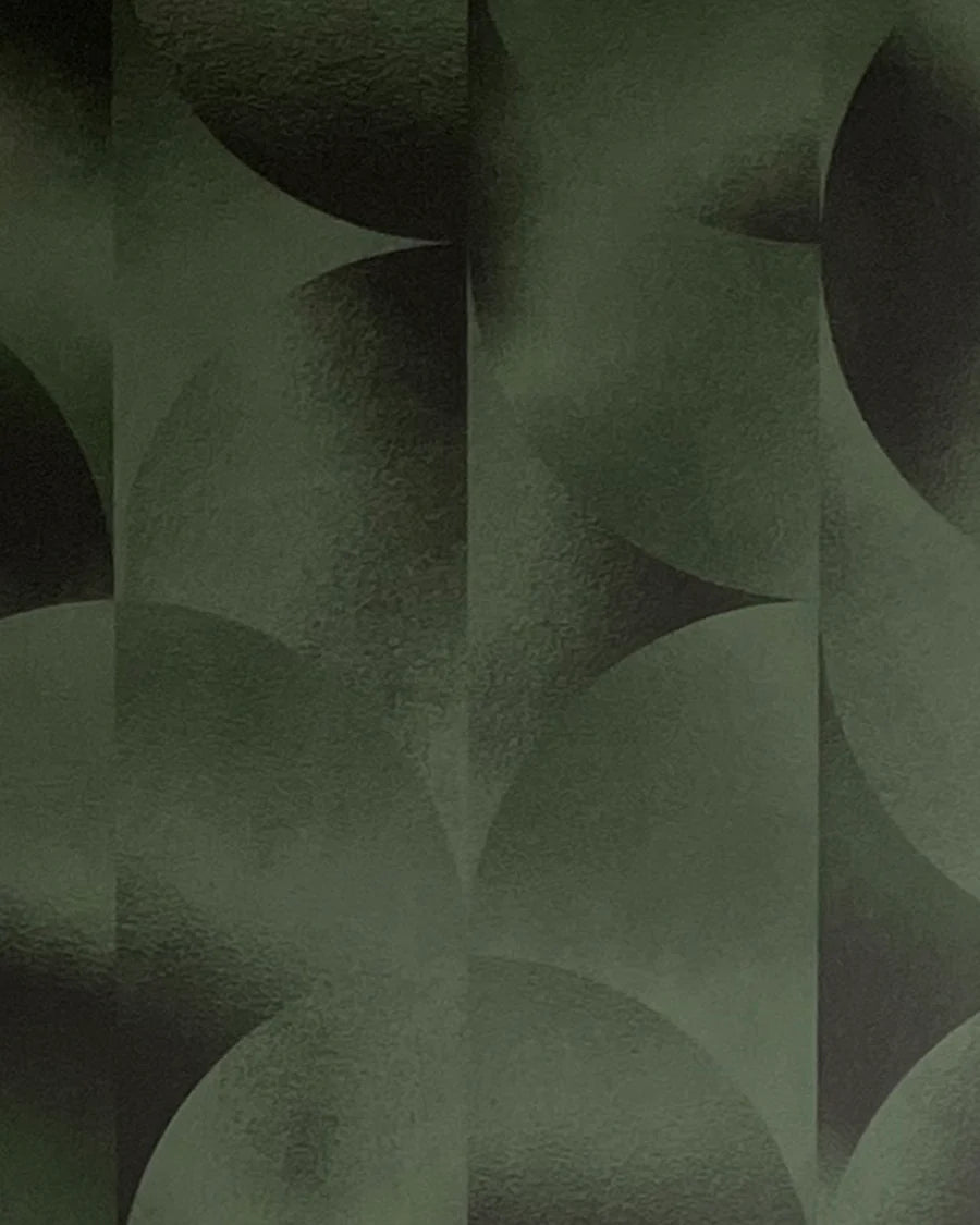 Detail of wallpaper in an abstract curvilinear print in mottled green and black.