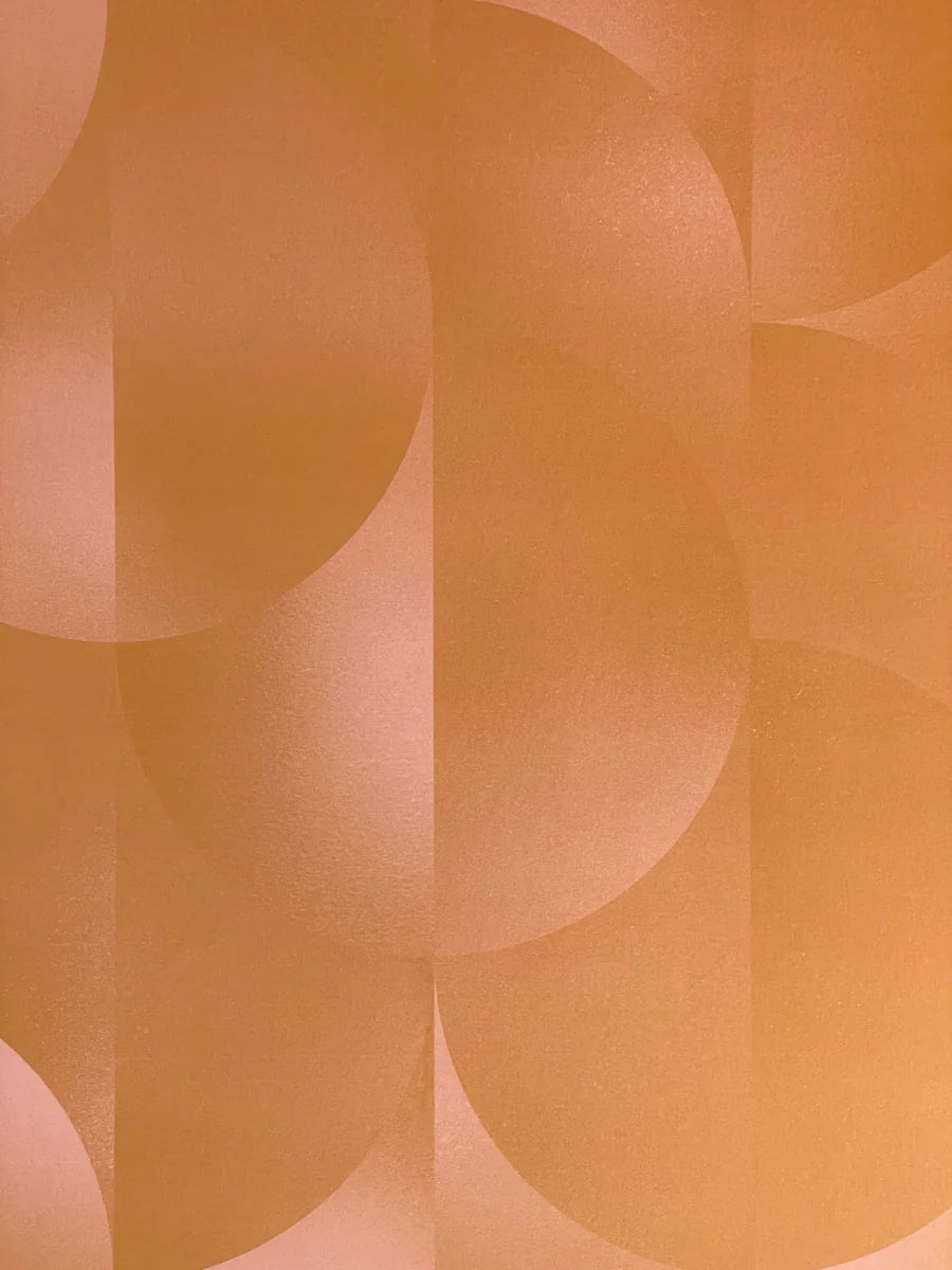 Detail of wallpaper in an abstract curvilinear print in mottled orange and pink.