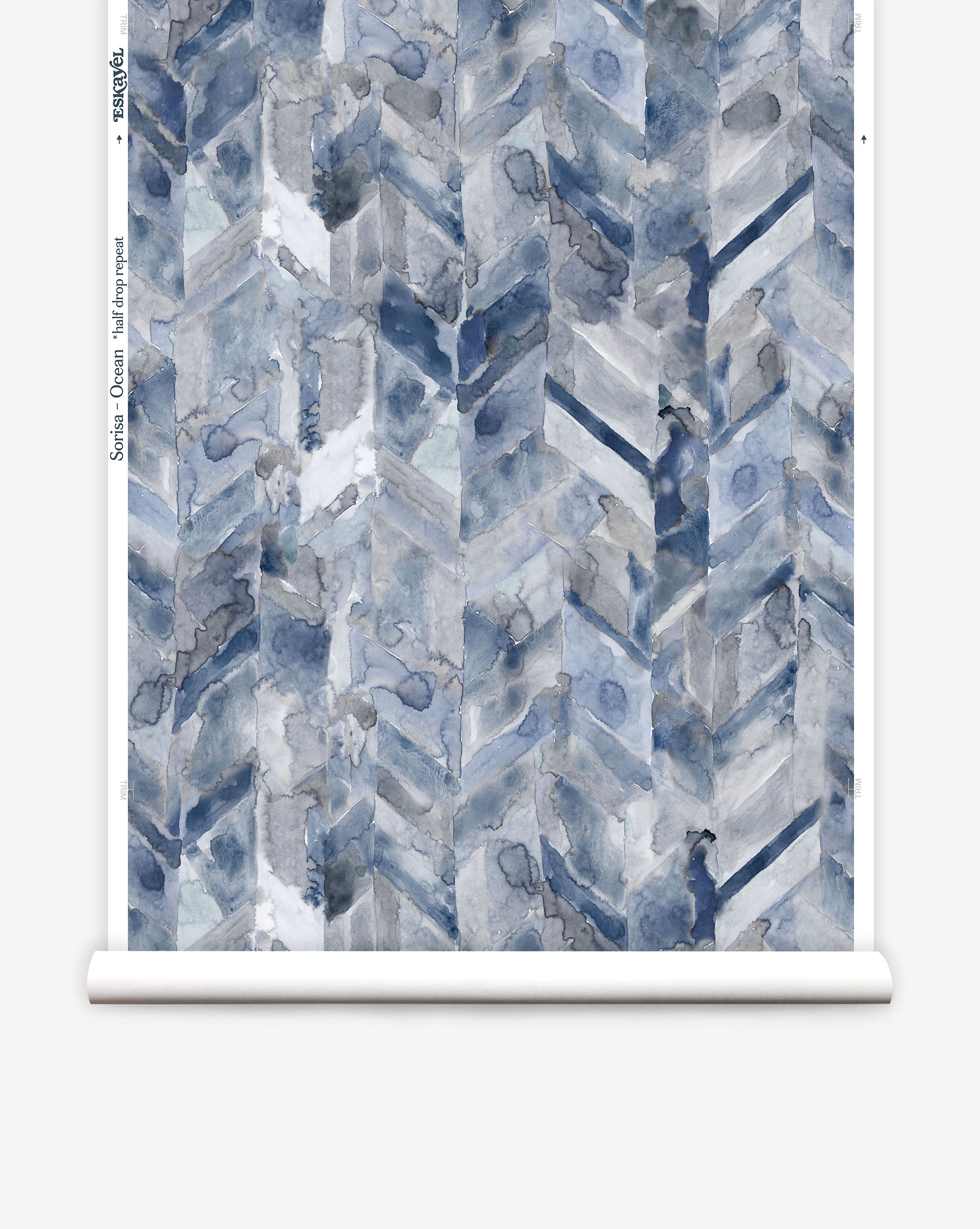 Partially unrolled wallpaper yardage in a painterly herringbone print in shades of blue and gray.