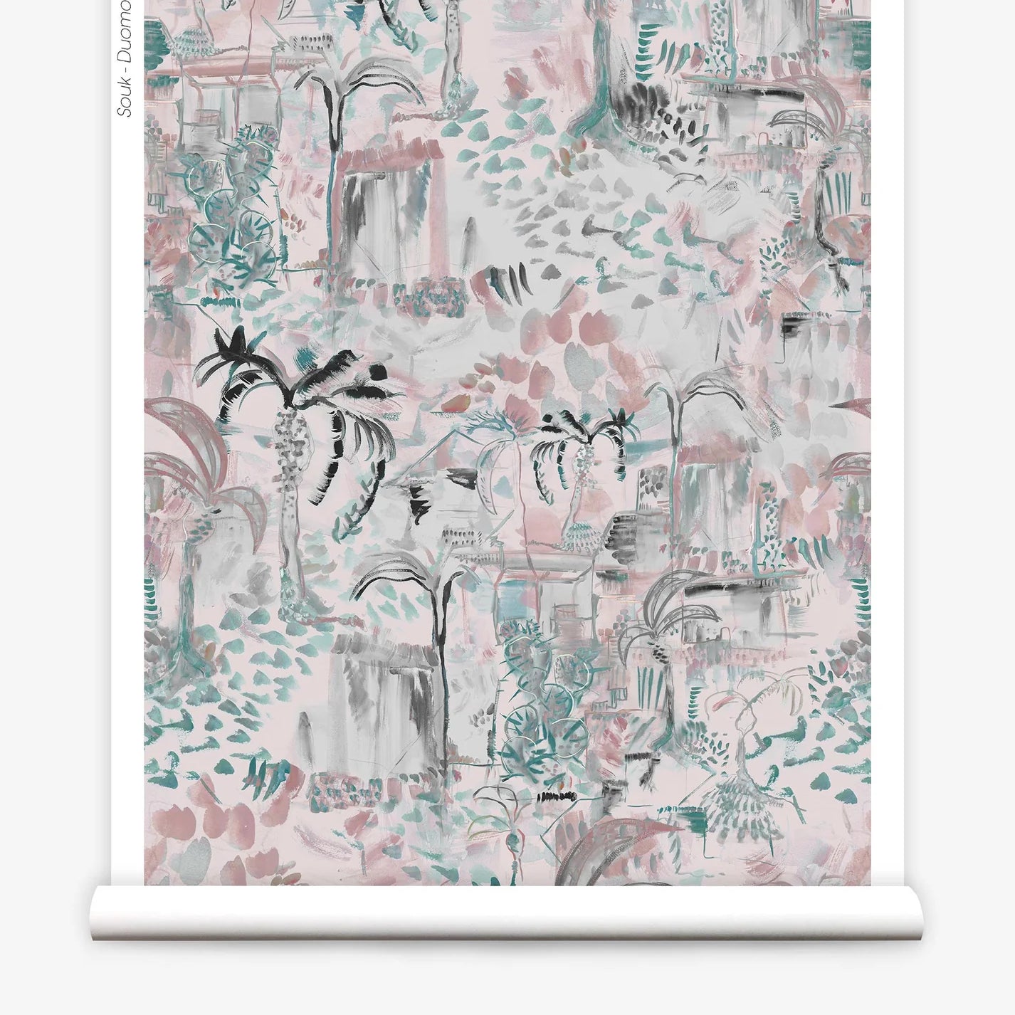 Partially unrolled wallpaper yardage in a painterly tree print in shades of gray, pink and turquoise.