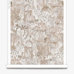 Partially unrolled wallpaper yardage in a painterly tree print in shades of gray, tan and cream.