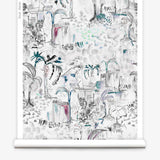 Partially unrolled wallpaper yardage in a painterly tree print in shades of gray, white, turquoise and pink.