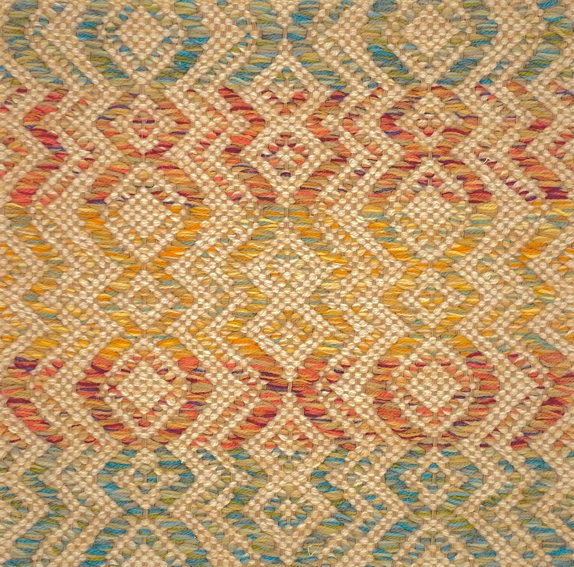 Flatweave rug in a raised diamond stripe in an ombre of green, orange and yellow
