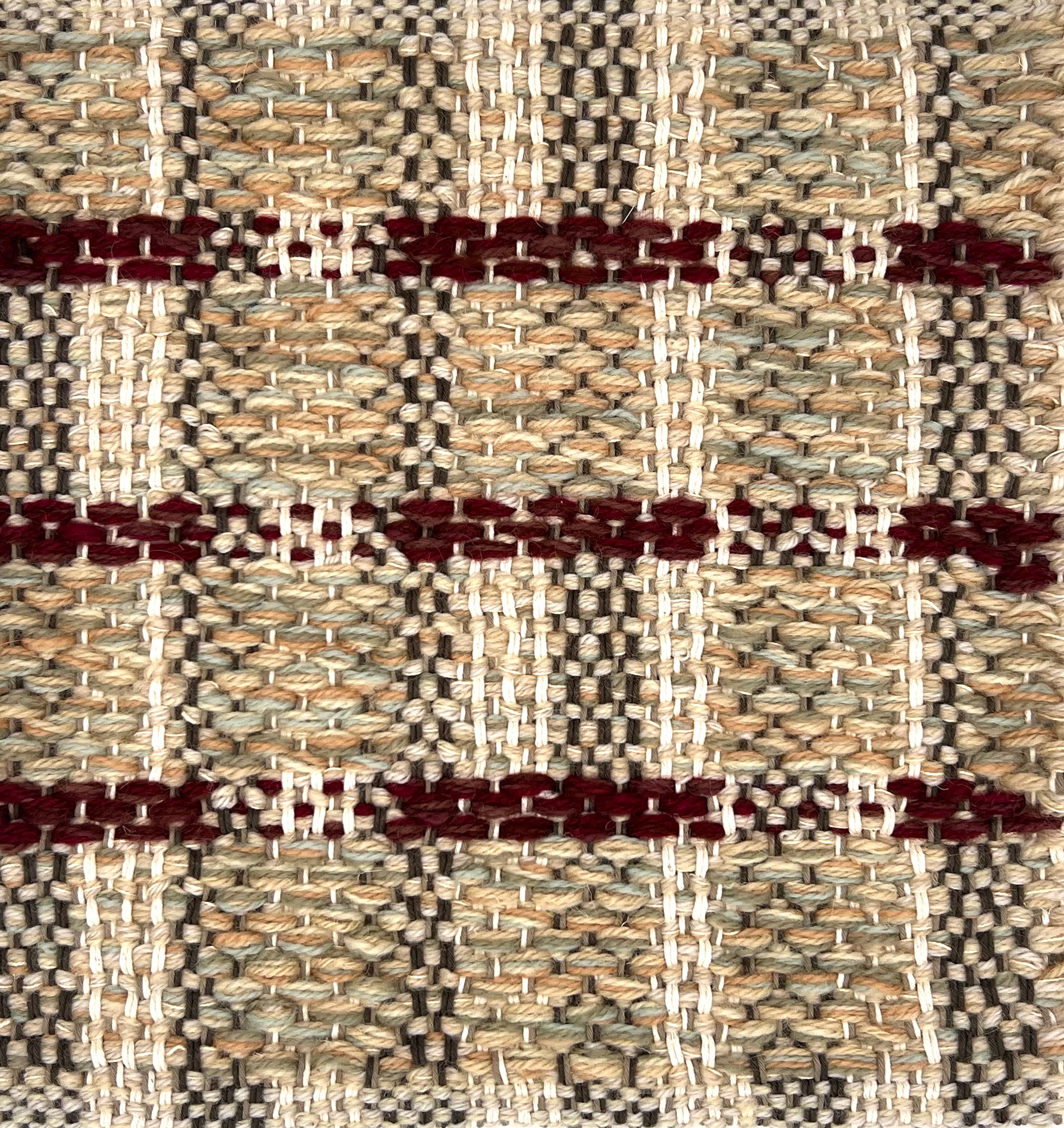 Textural flatweave rug in a tan and crimson contemporary check pattern.