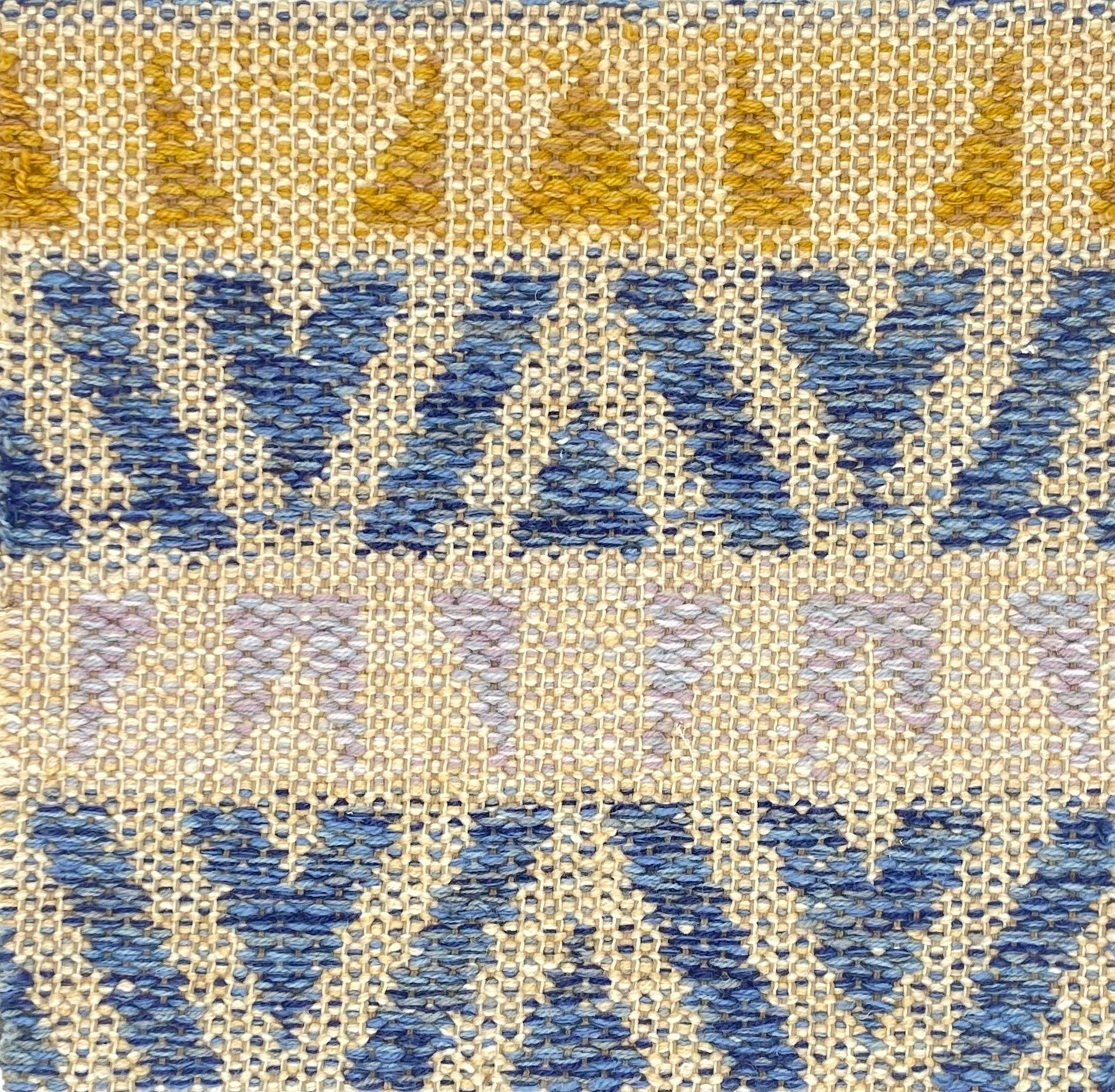 Flatweave rug in a playful geometric stripe design in yellow, blue and lilac on a beige field